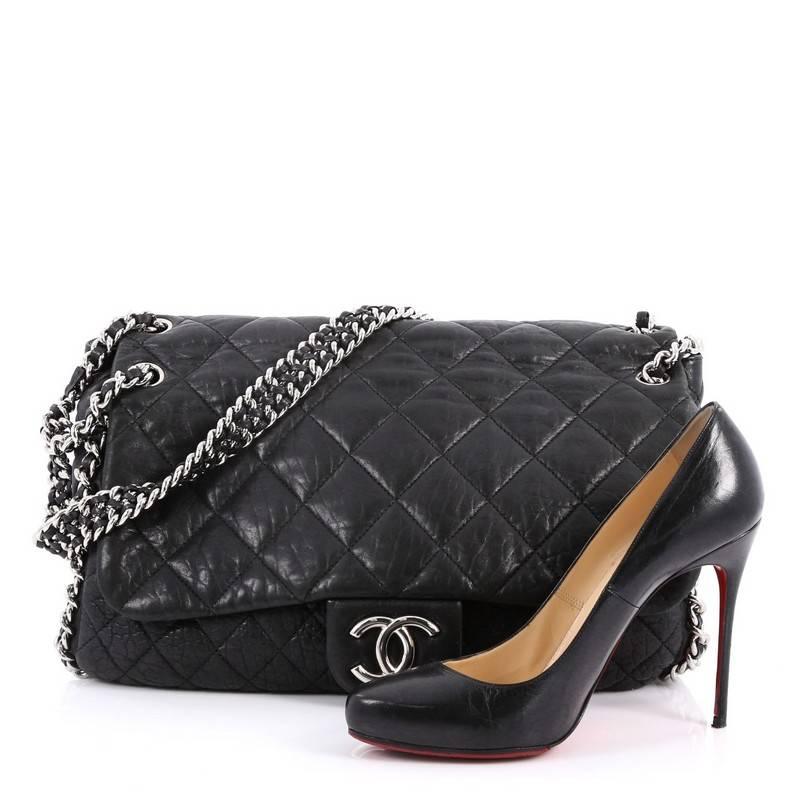 This authentic Chanel Chain Around Flap Bag Quilted Leather Maxi is a beautiful addition to your collection. Crafted in black quilted leather, this flap bag features woven-in leather chain straps with chain-around trims, frontal flap with CC logo,