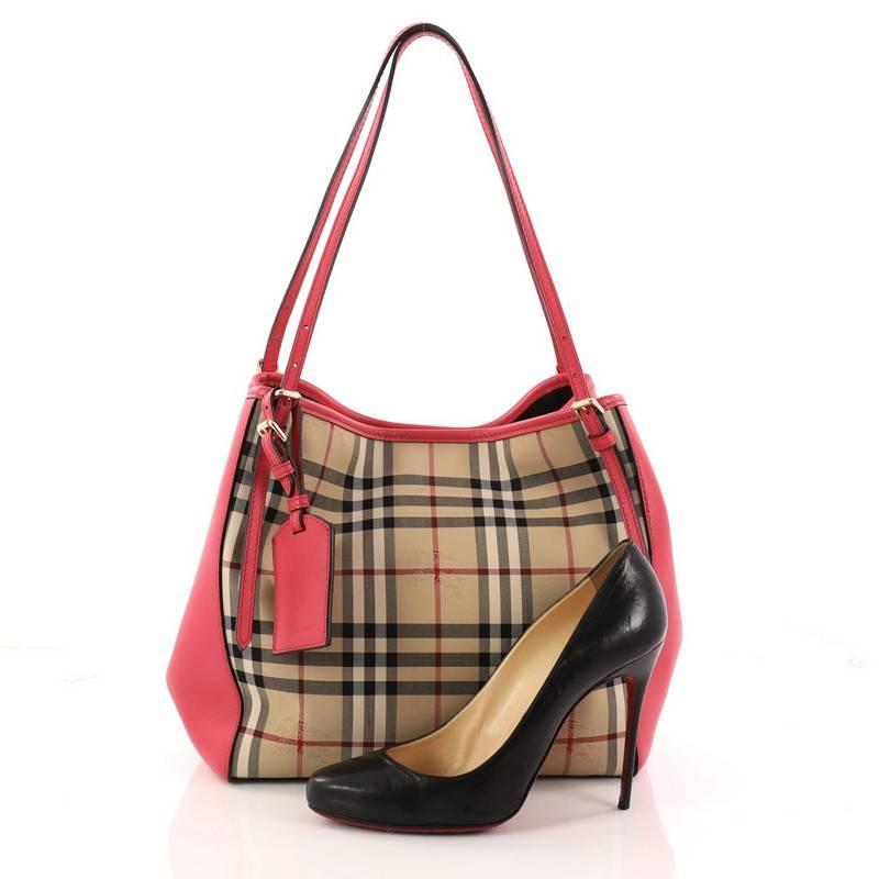 This authentic Burberry Canterbury Tote Horseferry Check Canvas and Leather Small is perfect for casual wear. Crafted in brand's signature tan horseferry check print in coated canvas with pink leather panels, this elegant tote features leather