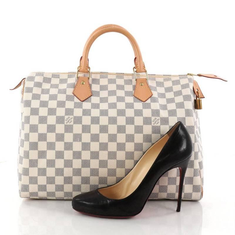 This authentic Louis Vuitton Speedy Handbag Damier 35 is a timeless favorite of many. Constructed from Louis Vuitton's signature damier azur coated canvas, this iconic Speedy features dual-rolled handles, vachetta leather trims and gold-tone