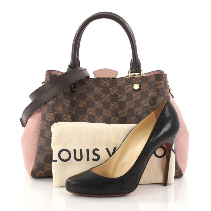 This authentic Louis Vuitton Brittany Handbag Damier makes an elegant statement. Crafted from damier ebene coated canvas and pink cuir taurillon leather, this sophisticated bag features dual-rolled leather handles, smooth brown cowhide leather trim,