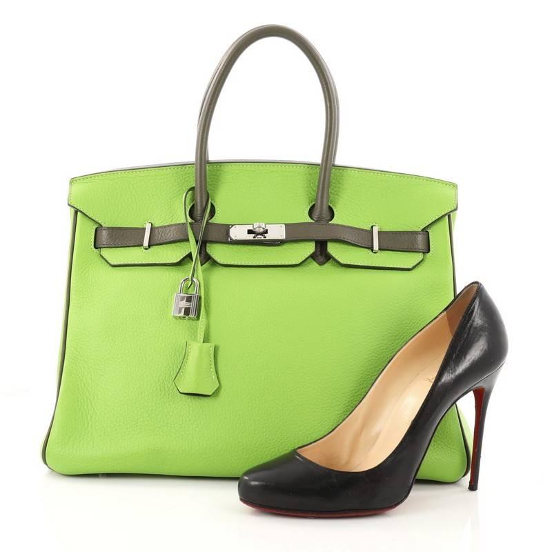This authentic Hermes Birkin Handbag Bicolor Clemence with Palladium Hardware 35 stands as one of the most-coveted bags. Constructed from scratch-resistant granny and  olive green bicolor clemence leather, this stand-out tote features dual-rolled