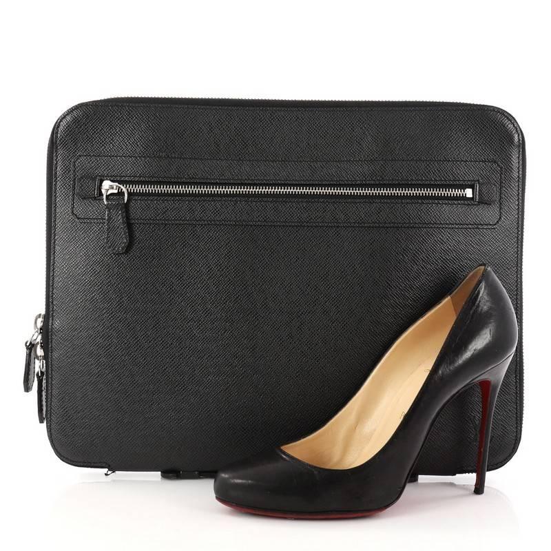 This authentic Louis Vuitton Vladimir Portfolio Bag Taiga Leather is a gorgeous case that displays both the style and the quality you desire from a professional bag. Crafted in black taiga leather, this chic portfolio bag features an exterior zip