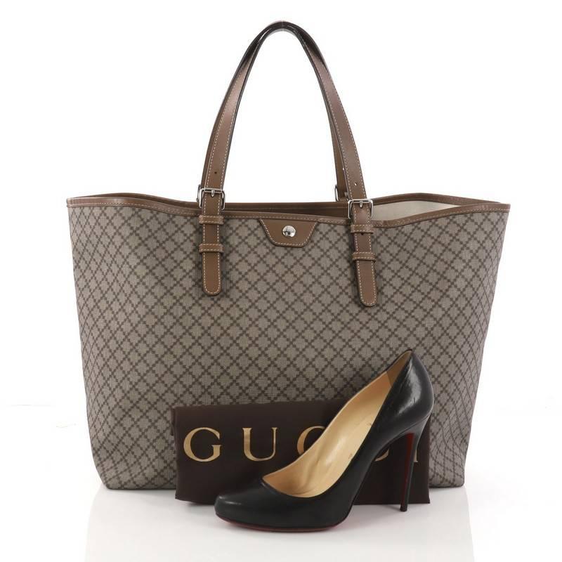 This authentic Gucci Belted Tote Diamante Coated Canvas Large is your ideal everyday bag. Crafted in taupe diamante coated canvas, this tote features adjustable dual-flat leather handles, and silver-tone hardware accents. It opens to an off-white