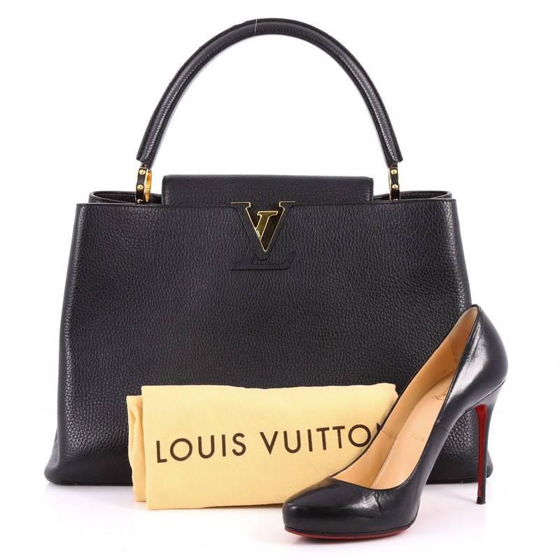This authentic Louis Vuitton Capucines Handbag Leather GM is sophisticated and fresh in design. Crafted from black taurillon leather, this ultra-chic bag features a single rolled leather handle secured by jewel-like rings, top flap with the classic