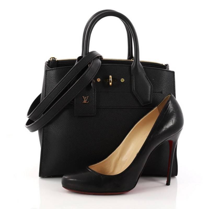 This authentic Louis Vuitton City Steamer Handbag Leather PM is a versatile design. Crafted in black leather, this modern tote features dual-rolled leather handles, front central lock with LV stamped logo, protective base studs and gold-tone