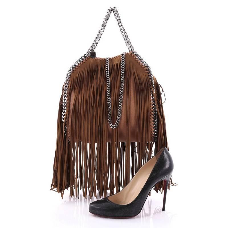 This authentic Stella McCartney Falabella Fringe Fold Over Crossbody Bag Shaggy Deer Mini is perfect for casual day-to-day excursions with an edgy twist. Crafted in dark brown fringe shaggy deer, this luxurious bag features slinky chain handles,