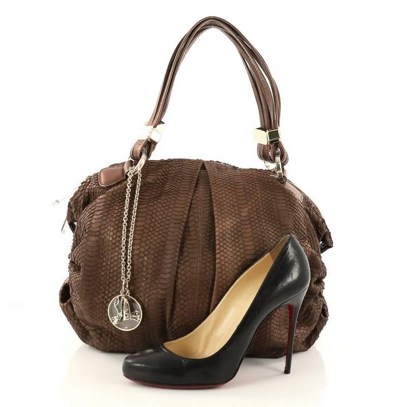 This authentic Christian Louboutin Pleated Shoulder Bag Python Medium is perfect for everyday use. Crafted in genuine brown python skin, this feminine, shoulder bag features pleated silhouette, leather shoulder straps, protective base studs and