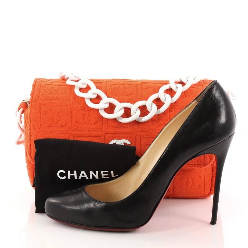 This authentic Chanel Sport Line Resin Camera Flap Bag Terry Cloth Medium is a fun and chic bag perfect to match your casual looks. Crafted in orange terry cloth fabric, this bag features frontal flap with white resin CC logo, resin chain strap and