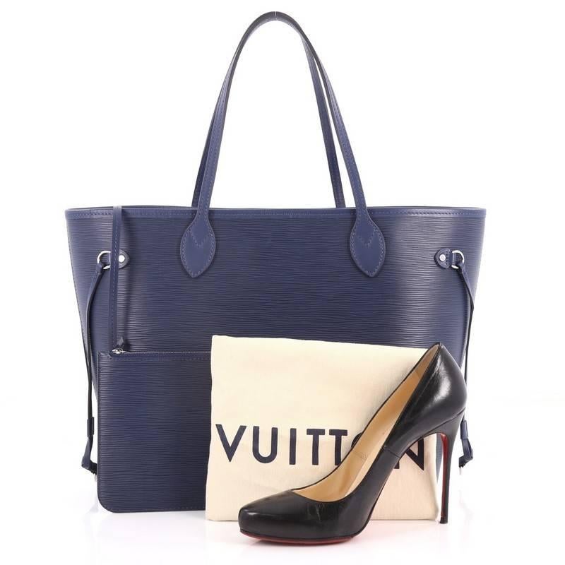 This authentic Louis Vuitton Neverfull Tote Epi Leather MM is a perfect companion for daily excursions. Crafted in blue epi leather, this iconic easy-to-carry tote features dual flat leather handles, side tassels that cinch and expand, and