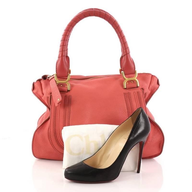 This authentic Chloe Marcie Shoulder Bag Leather Medium is perfect for the on-the-go fashionista. Constructed from pink leather, this popular satchel features wrapped leather handles, horseshoe stitched front flap, and gold-tone hardware. Its top