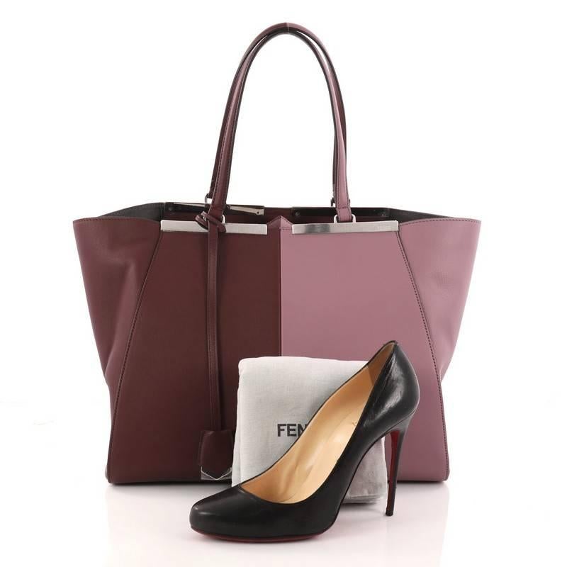 This authentic Fendi Bicolor 3Jours Handbag Leather Large updated from its popular predecessor the 2Jour tote is impeccably stylish. Crafted in bicolor purple and maroon leather, this minimalist tote features a shining split top bar that dons Fendi