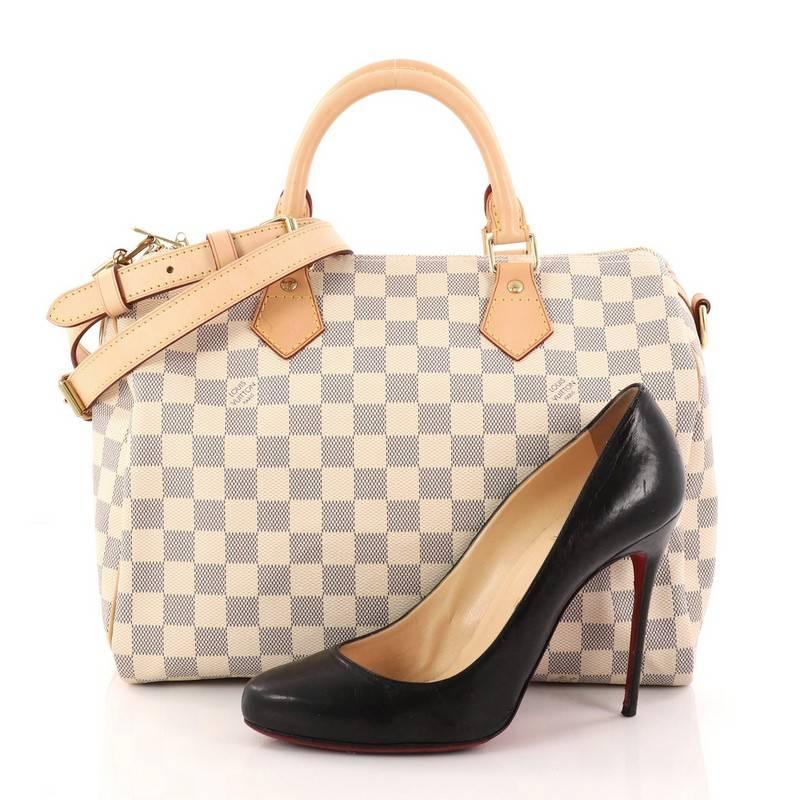 This authentic Louis Vuitton Speedy Bandouliere Bag Damier 30 is a classic must-have that will never go out of style. Constructed in Louis Vuitton's classic damier azur coated canvas , this iconic Speedy features dual-rolled vachetta leather