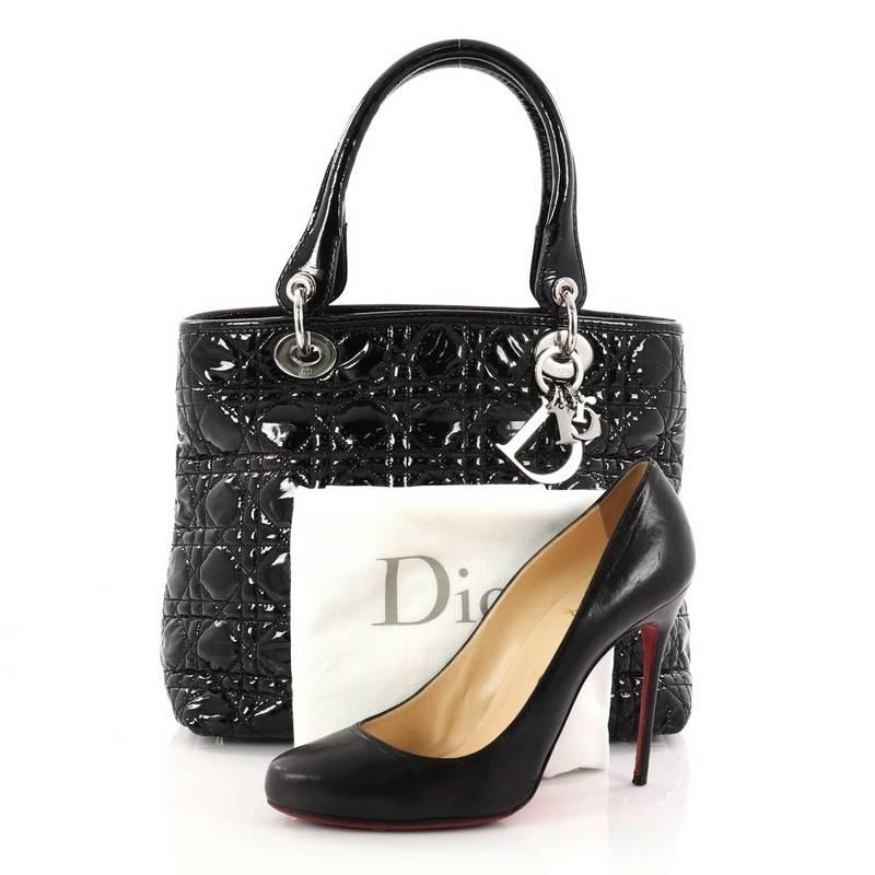 This authentic Christian Dior Lady Dior Soft Tote Cannage Quilt Patent Large is a classic staple that every fashionista needs in her wardrobe. Crafted from black patent leather with Dior's iconic cannage stitching, this easy-chic bag features