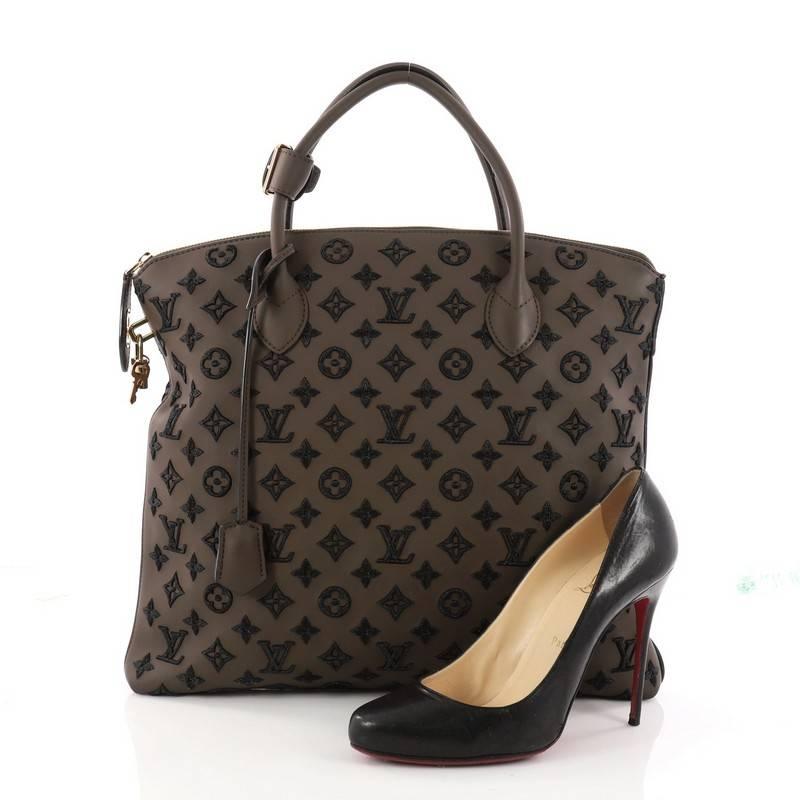 This authentic Louis Vuitton Lockit Handbag Limited Edition Monogram Addiction Rubber Vertical is unusual and unique in design. Crafted in brown synthetic rubber, this unique bag is embroidered with lam̩ threads to create the classic monogram