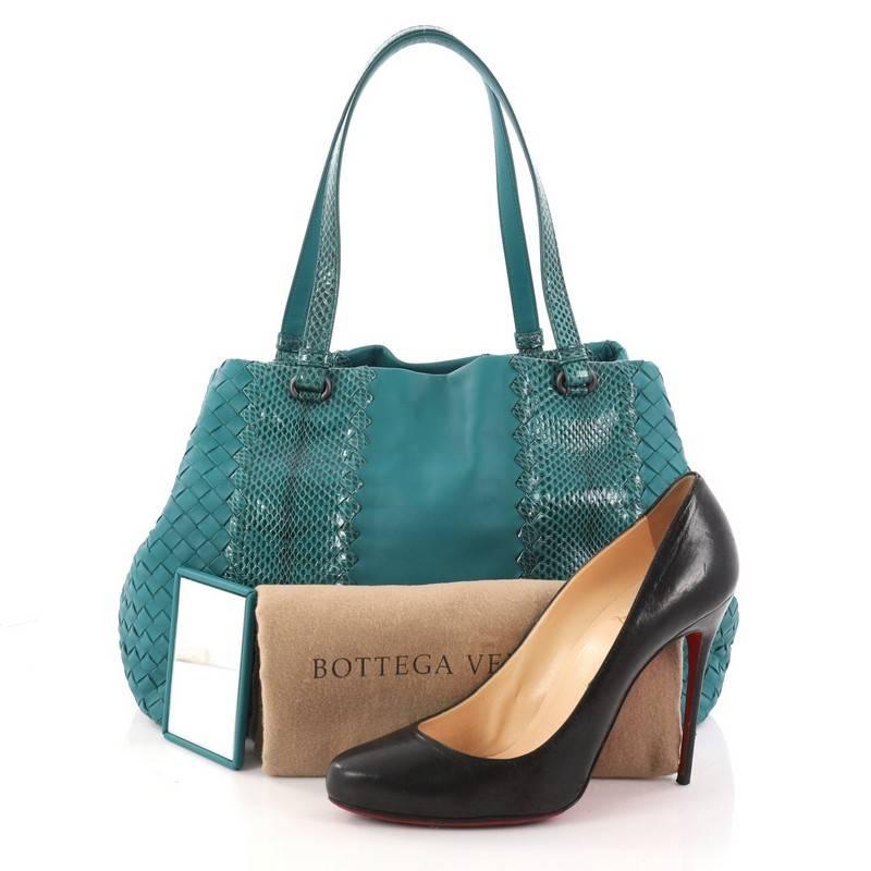 This authentic Bottega Veneta A-Shape Tote Intrecciato Nappa with Python Detail Medium is a statement piece you can surely take from day to night. Crafted in teal leather woven in Bottega Veneta's signature intrecciato method with genuine python
