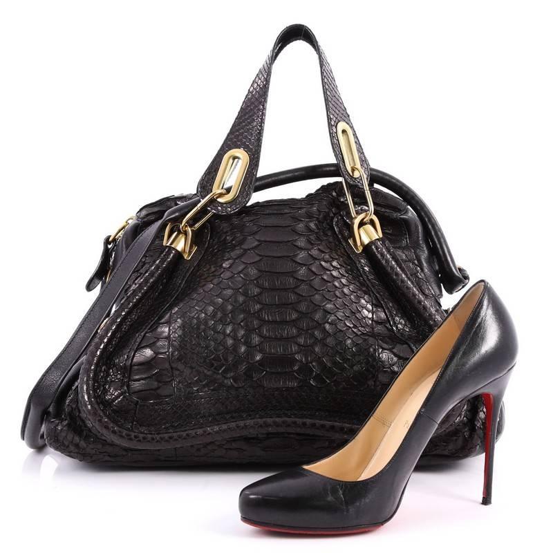 This authentic Chloe Paraty Top Handle Bag Python Medium mixes everyday style and functionality perfect for the modern woman. Crafted from genuine black python skin and leather, this versatile bag features dual flat handles, piped trim details, side