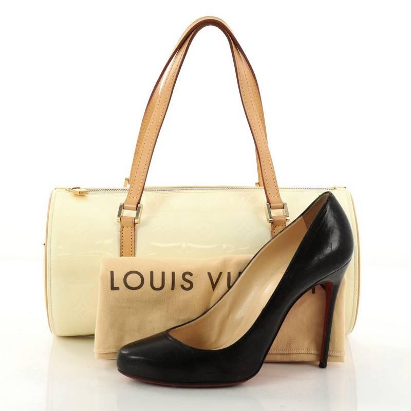 This authentic Louis Vuitton Bedford Handbag Monogram Vernis is a fabulous bag for any fashionista on-the-go. Crafted from beige monogram vernis leather, this stunning bag features dual-flat leather handles, vachetta leather trims, classic rounded