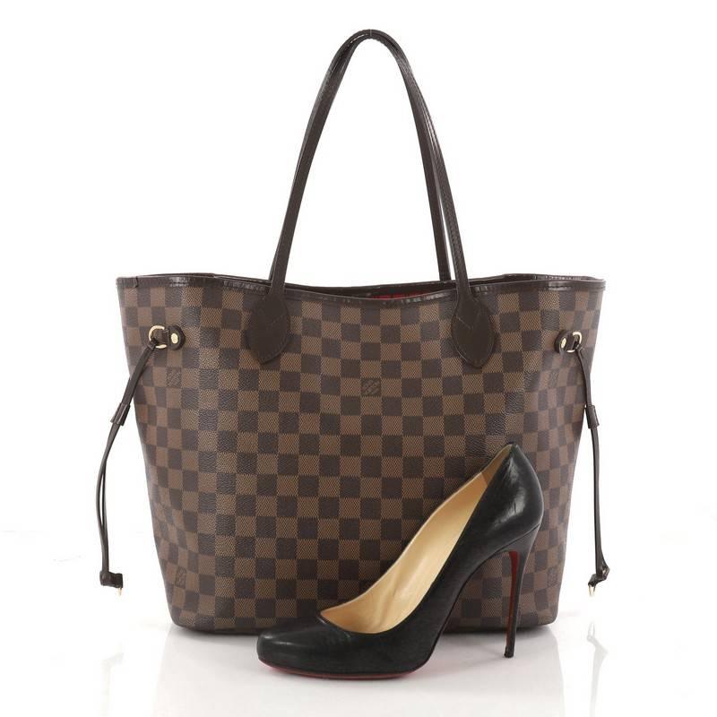 This authentic Louis Vuitton Neverfull Tote Damier MM is a popular and practical oversized tote beloved by many. Constructed with Louis Vuitton's signature damier ebene coated canvas, this tote features dual slim vachetta handles, side laces can be
