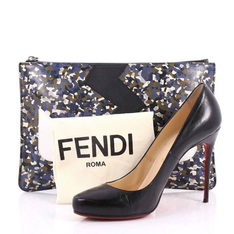 This authentic Fendi Monster Pouch Printed Leather Medium mixes bold and chic style perfect for daily use. Crafted from blue printed leather, this pouch features eye-catching white monster eye applique design and silver hardware accents. Its zip