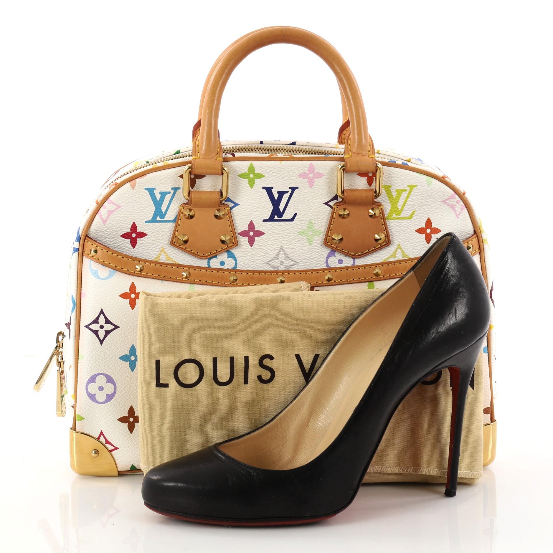 This authentic Louis Vuitton Trouville Handbag Monogram Multicolor is the perfect accessory for day to night use. Crafted with Louis Vuitton's signature white multicolor monogram coated canvas, this handy bag features dual-rolled handles, natural