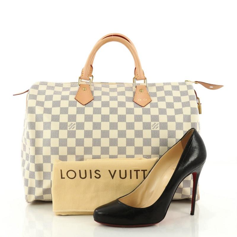 This authentic Louis Vuitton Speedy Handbag Damier 35 is a timeless favorite of many. Constructed from Louis Vuitton's signature damier azur coated canvas, this iconic Speedy features dual-rolled handles, vachetta leather trims and gold-tone