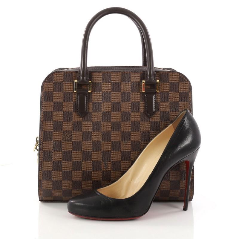 This authentic Louis Vuitton Triana Bag Damier is perfect with any casual outfit. Crafted from damier ebene coated canvas, this sturdy handle bag features dual-rolled leather handles, dark brown leather trims, exterior front and back compartments