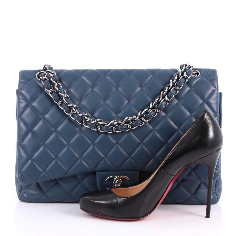 This authentic Chanel Classic Double Flap Bag Quilted Lambskin Maxi exudes a classic yet easy style made for the modern woman. Crafted from dark blue lambskin leather, this elegant flap features Chanel's signature diamond quilted design, woven-in