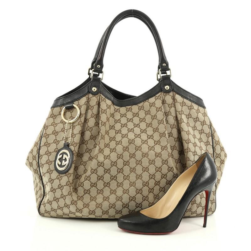 This authentic Gucci Sukey Tote GG Canvas Large is perfect for any casual or sophisticated outfit. Constructed from Gucci's brown GG monogram canvas with black leather trims, this roomy tote features dual-rolled leather handles that sit comfortably