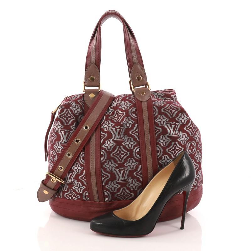 This authentic Louis Vuitton Aviator Handbag Limited Edition Monogram Jacquard is a collector's piece made for LV lovers. Crafted from dark red monogram fabric with brown and red leather panels and trims, this hard-to-find bag features dual-flat