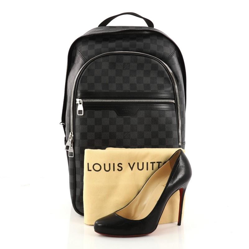 This authentic Louis Vuitton Michael Backpack Damier Graphite is a luxe backpack combining style and comfort. Crafted from damier graphite coated canvas, this chic backpack features a short flat leather handle, two canvas padded backpack straps,