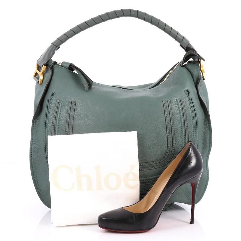 This authentic Chloe Marcie Hobo Leather Large showcases the brand's popular horseshoe design in a classic hobo design. Constructed from beautiful green leather, this functional yet stylish hobo bag features a slouchy, easy-to-carry silhouette,