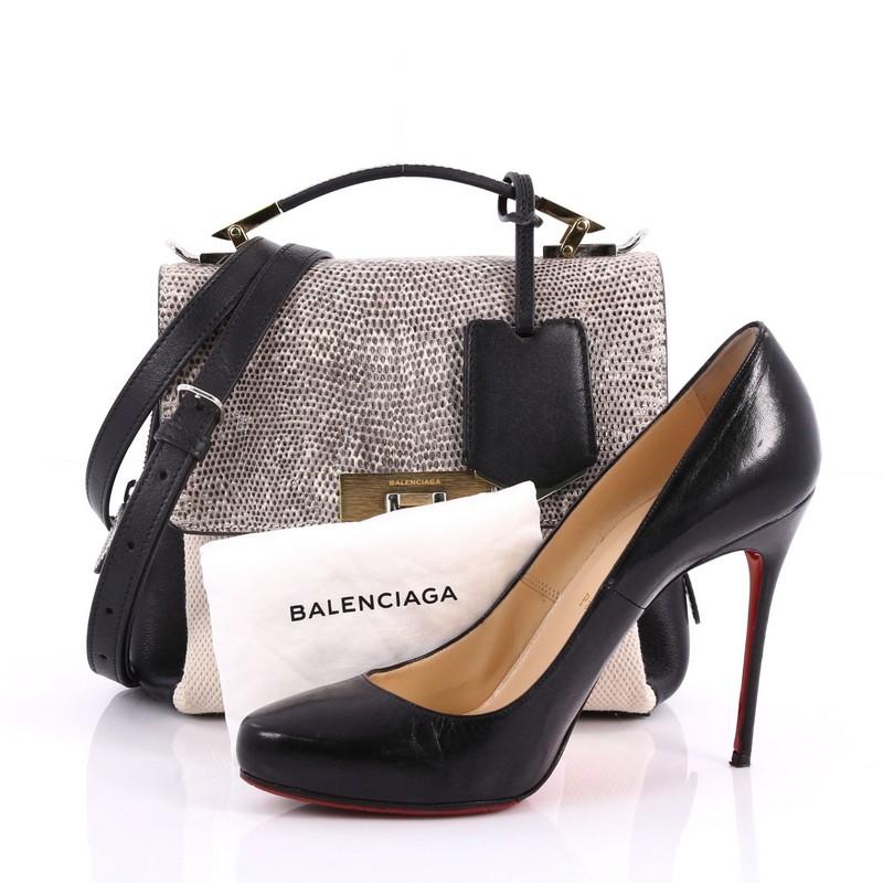 This authentic Balenciaga Le Dix Soft Cartable Top Handle Bag Mixed Media Mini inspired by the 10 Avenue George V flagship boutique is a luxurious and sophisticated bag made for everyday use. Crafted from beige and black mixed media, this beautiful