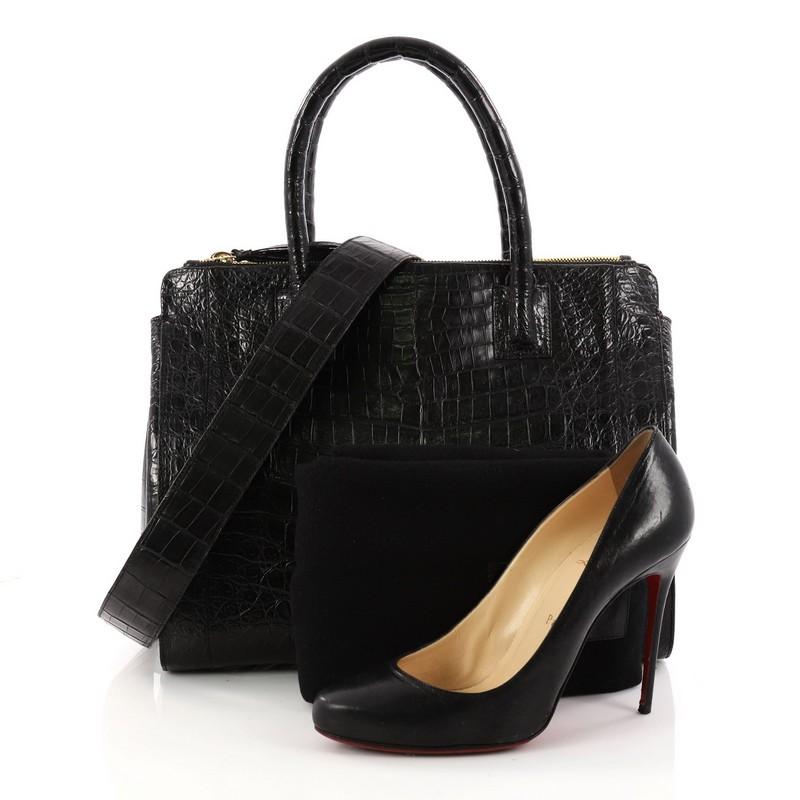 This authentic Nancy Gonzalez Double Zip Convertible Tote Crocodile Large is the perfect combination of luxurious style and a polished aesthetic with a fun twist. Crafted from genuine black crocodile skin, this tote features a subtly pleated