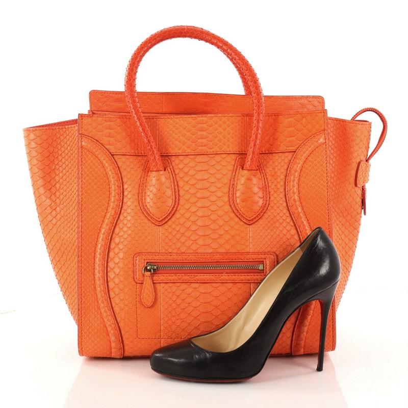 This authentic Celine Luggage Handbag Python Mini epitomizes Phoebe Philo's minimalist yet chic style with an exotic, luxurious twist. Constructed in genuine orange python skin, this beloved exotic fashionista's bag features dual-rolled handles, a