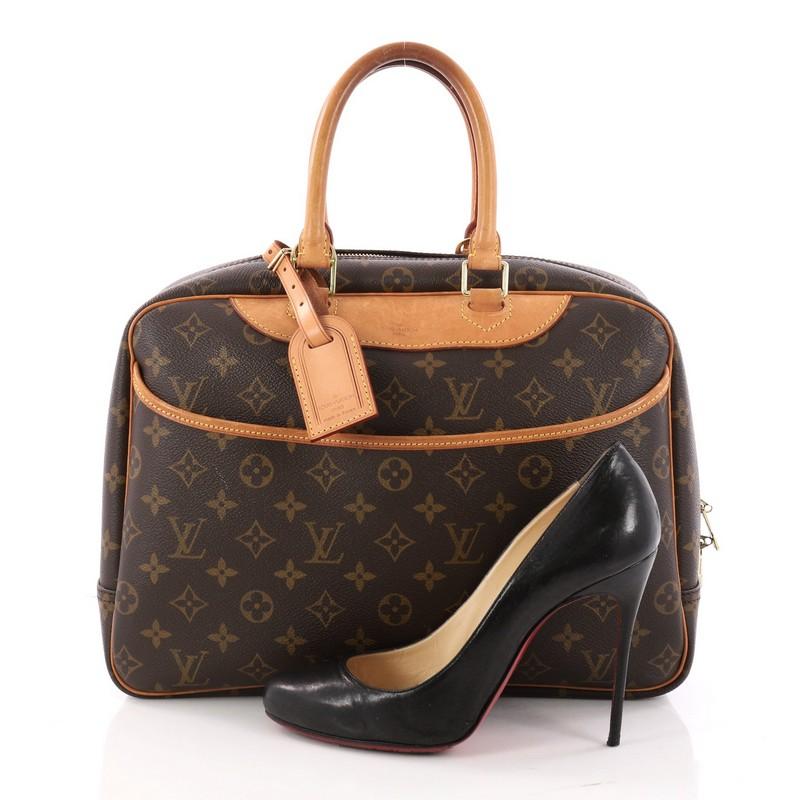 This authentic Louis Vuitton Deauville Handbag Monogram Canvas was popularly known as a vanity case, yet has become an everyday staple. Constructed from brown monogram coated canvas, this bag features dual rolled vachetta leather handles and trims,