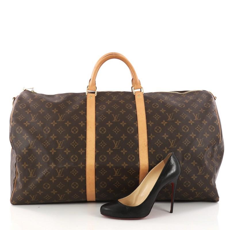 This authentic Louis Vuitton Keepall Bandouliere Bag Monogram Canvas 55 is the perfect purchase for a weekend trip, and can be effortlessly paired with any outfit from casual to formal. Crafted with traditional Louis Vuitton brown monogram coated