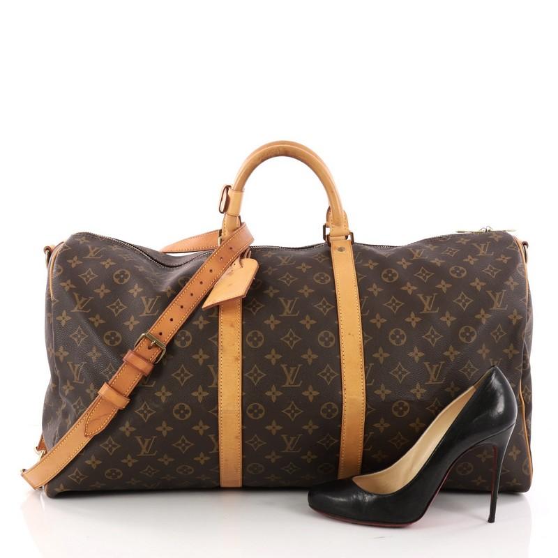 This authentic Louis Vuitton Keepall Bandouliere Bag Monogram Canvas 55 is the perfect purchase for a weekend trip, and can be effortlessly paired with any outfit from casual to formal. Crafted with traditional Louis Vuitton brown monogram coated