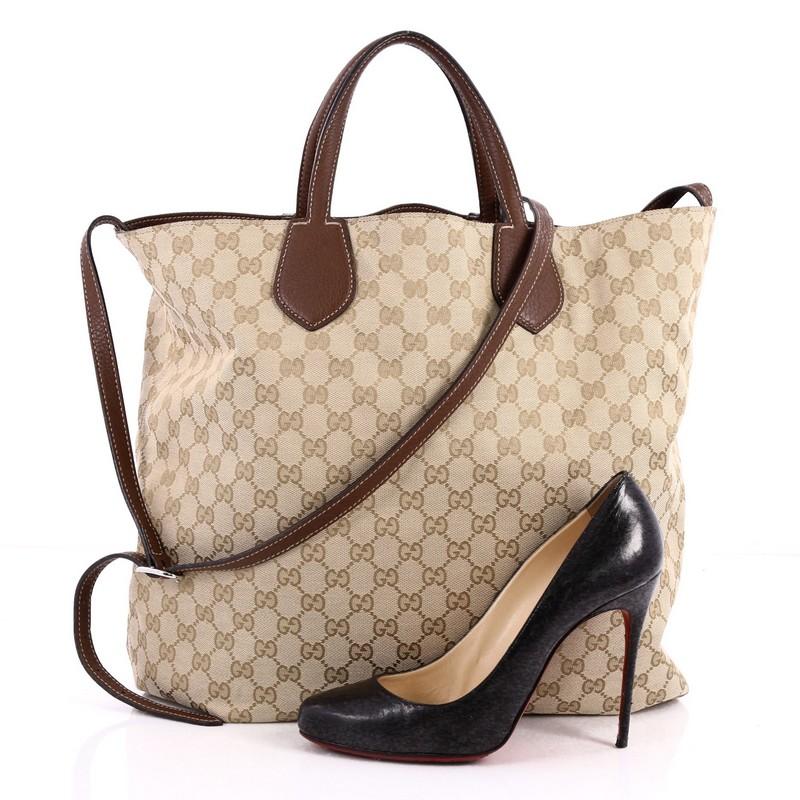 This authentic Gucci Ramble Reversible Tote GG Canvas and Leather Large is perfect for everyday casual looks. Crafted in reversible brown GG canvas and leather with standout contrast stitching, this simple shopper-style tote features dual slim