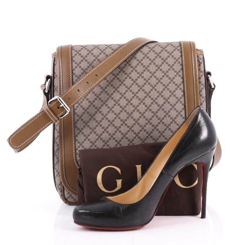 This authentic Gucci Snap Flap Messenger Bag Diamante Coated Canvas Medium is a classic piece for Gucci lovers. Crafted in brown diamante coated canvas with brown leather trims, this chic messenger bag features an adjustable leather strap, stand-out