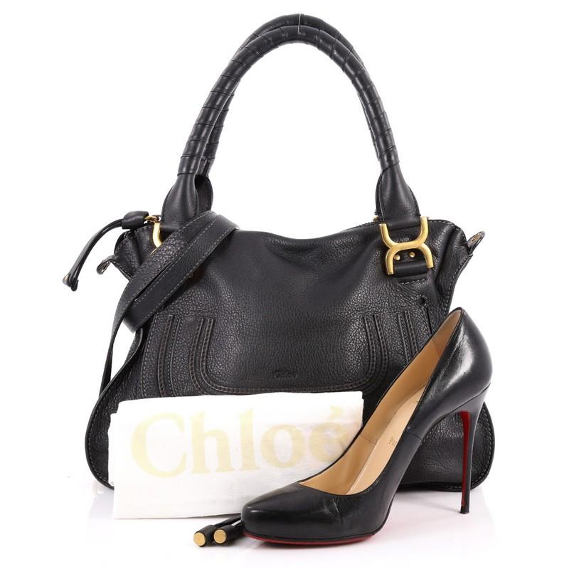 This authentic Chloe Marcie Satchel Leather Medium is perfect for the on-the-go fashionista. Constructed from black leather, this popular satchel features wrapped leather handles, horseshoe stitched front flap, and matte gold-tone hardware. Its top