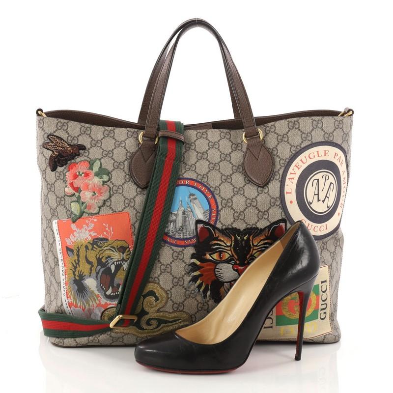 This authentic Gucci Convertible Courrier Soft Open Tote GG Coated Canvas with Applique Large is a source of travel inspiration for Gucci's creative director Alessandro Michele. Crafted in taupe GG coated canvas with brown leather trims, this chic