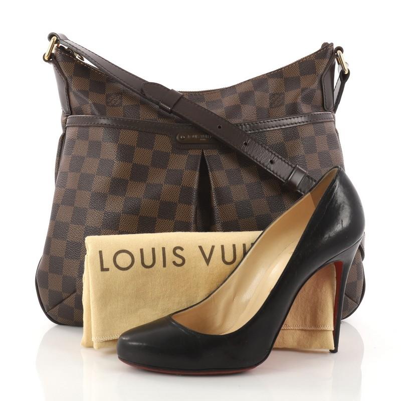 This authentic Louis Vuitton Bloomsbury Handbag Damier PM is a feminine yet versatile everyday bag made for the modern woman. Constructed from damier ebene coated canvas, this luxurious bag features an adjustable shoulder strap, dark brown leather