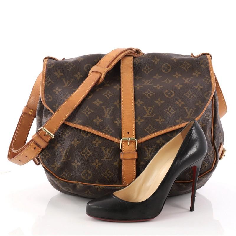 This authentic Louis Vuitton Saumur Handbag Monogram Canvas MM showcases the brand's reinterpretation of the classic saddle bag. Crafted in Louis Vuitton's popular brown monogram coated canvas, this bag features long adjustable strap, double saddle