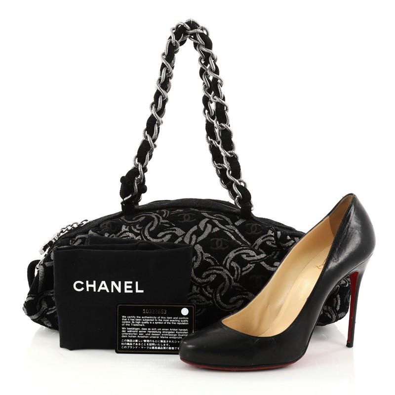 This authentic Chanel Zip Bowler Bag Chain Print Tweed Large showcases an edgy appeal and playful sporty style perfect for avid Chanel lovers. Crafted from black and silver printed tweed, this bowler bag features dual braided tweed chain straps,
