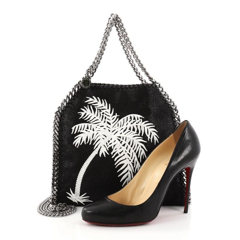 This authentic Stella McCartney Falabella Fold Over Crossbody Bag Embroidered Shaggy Deer Mini is a relaxed, modern crossbody made for on-the-go moments. Crafted from black shaggy deer with embroidered palm tree at front, this no-fuss, easy tote