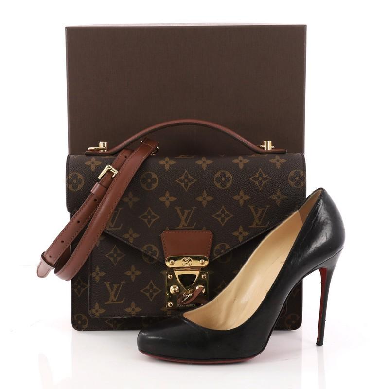 This authentic Louis Vuitton Monceau Handbag Monogram Canvas is a bag with a vintage touch. Crafted from brown monogram coated canvas, this chic bag features leather top handle, adjustable long leather strap, gusseted pocket under flap, sleek