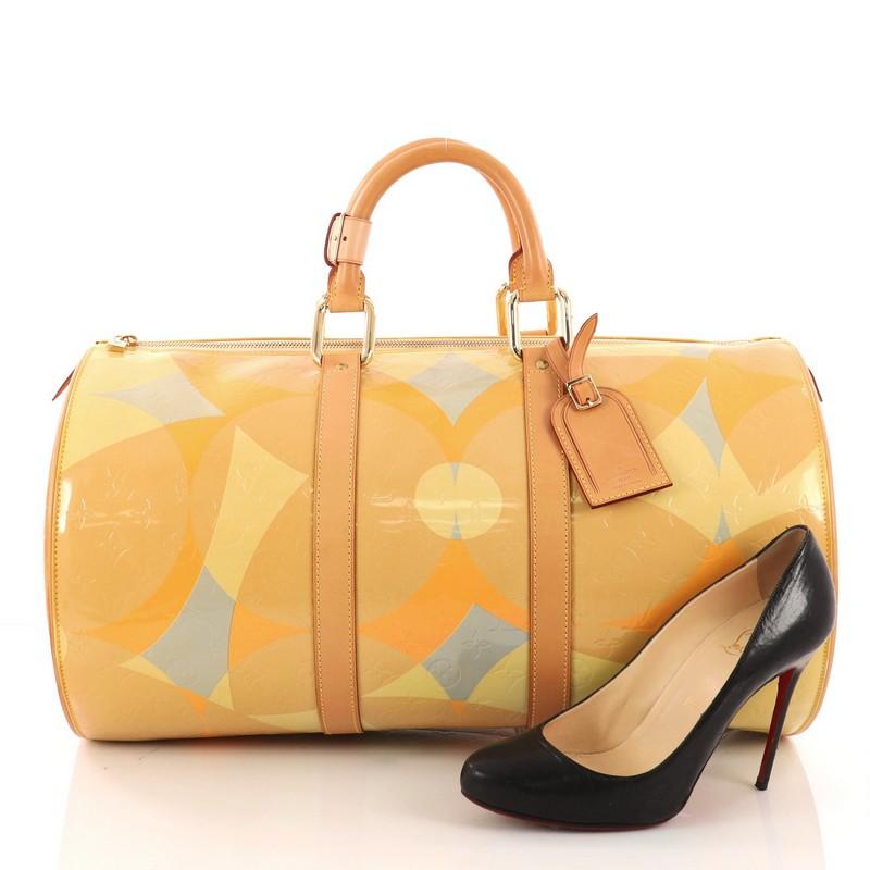 This authentic Louis Vuitton Barrel Keepall Handbag Fleur Monogram Vernis 45 is the perfect travel bag for any fashionista. Crafted in monogram vernis leather with an abstract floral pattern, this rare bag features dual-rolled leather handles,