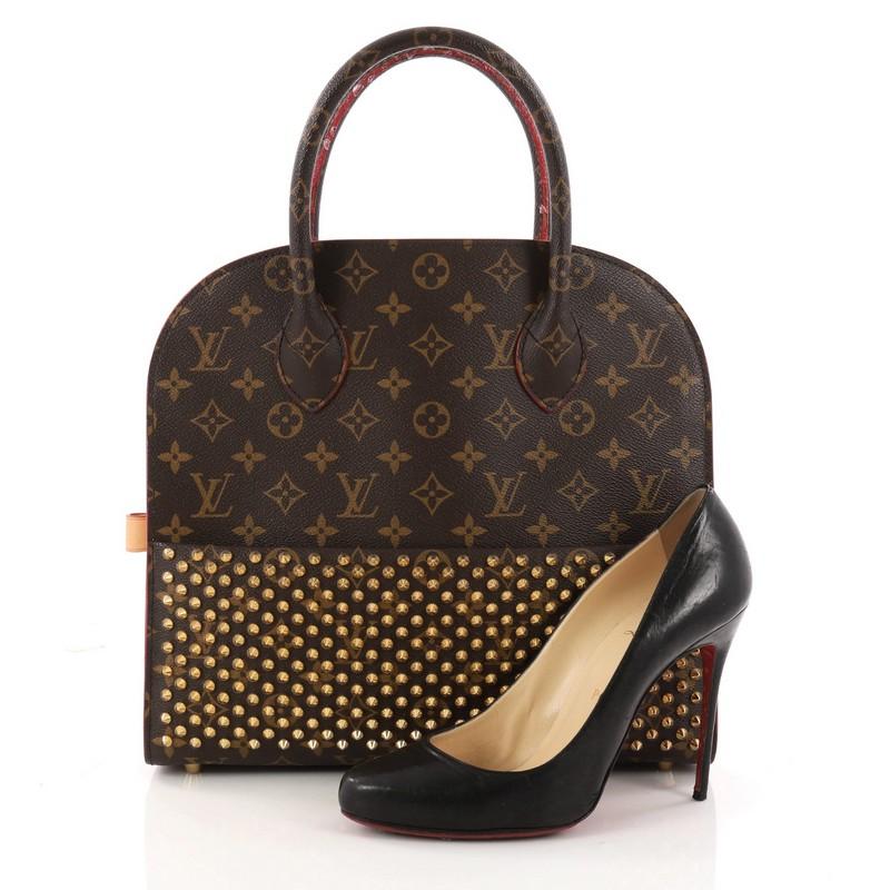This authentic Louis Vuitton Limited Edition Christian Louboutin Shopping Bag Calf Hair and Monogram Canvas is from the brand's 2014 exclusive Celebrating Monogram Collection. Created by famed shoe designer Christian Louboutin, this limited edition