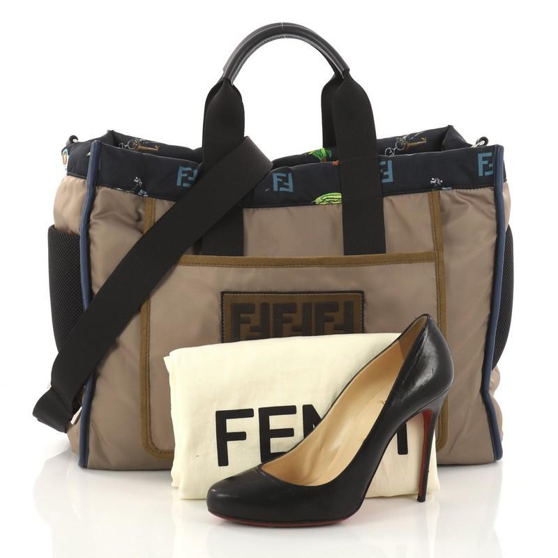 This authentic Fendi Reversible Tote Printed Nylon Large is perfect for everyday casual looks. Crafted in army green nylon, this chic bag features dual flat handles, large patch pocket and the two side pockets in technical mesh which are functional