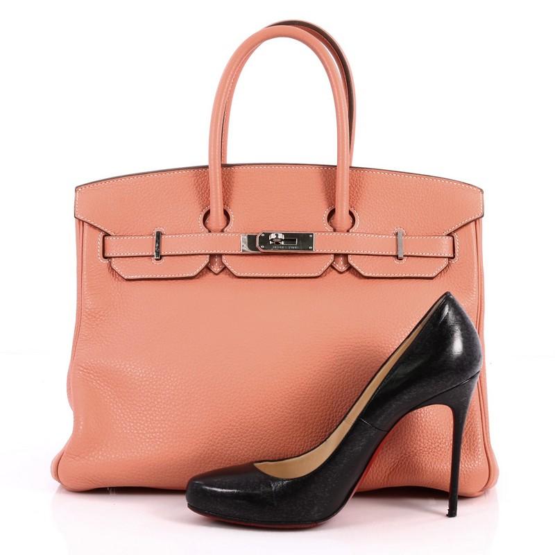 This authentic Hermes Birkin Handbag Crevette Pink Clemence with Palladium Hardware 35 is synonymous to traditional Hermes luxury. Crafted with sturdy, scratch-resistant crevette pink clemence leather, this eye-catching luxurious tote is accented